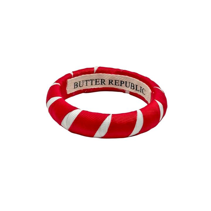red and white Butter Republic bracelet with a logo brand label on the interior of the bracelet
