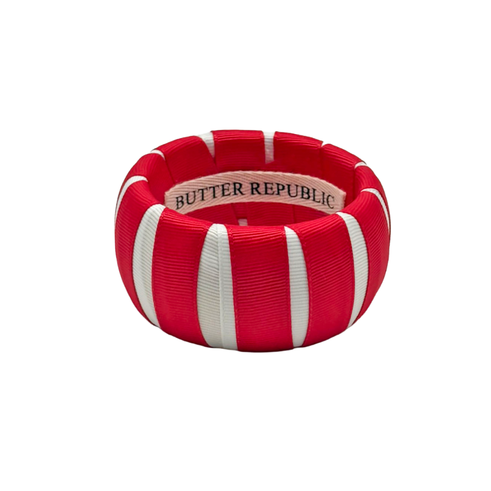 red and white Butter Republic bracelet with a logo brand label on the interior of the bracelet