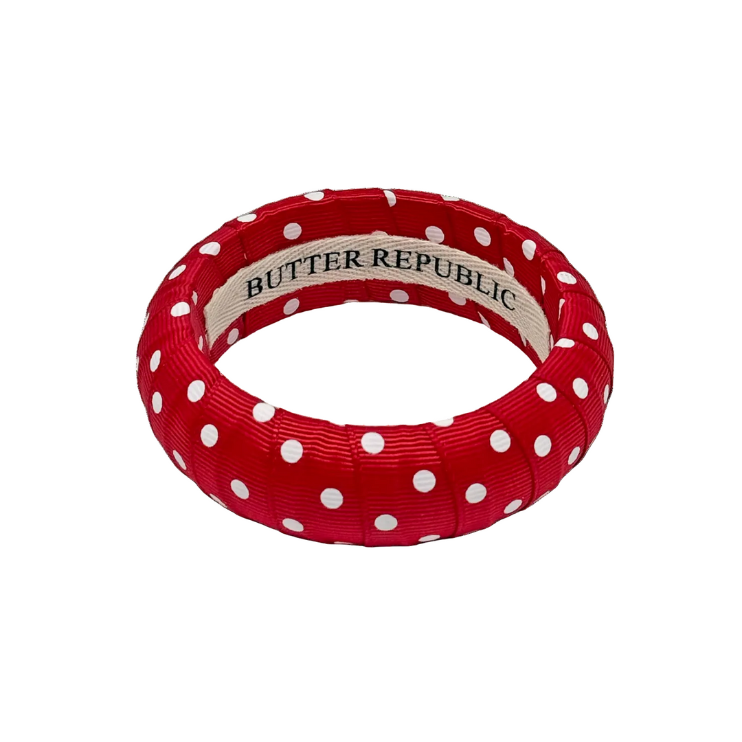 Red and white polka dot bracelet with Butter Republic brand label on the interior