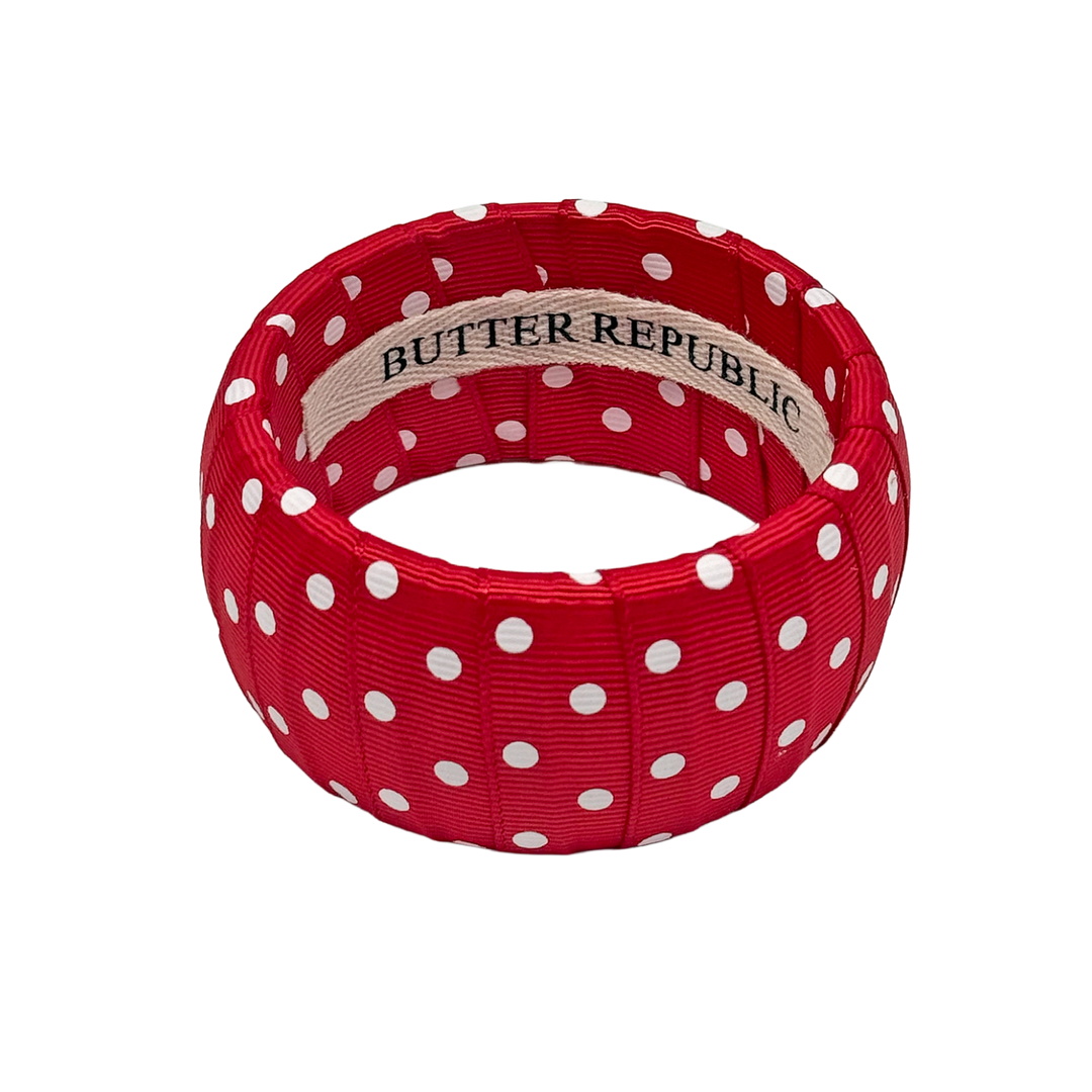 Red and white polka dot bracelet with Butter Republic branding on the interior