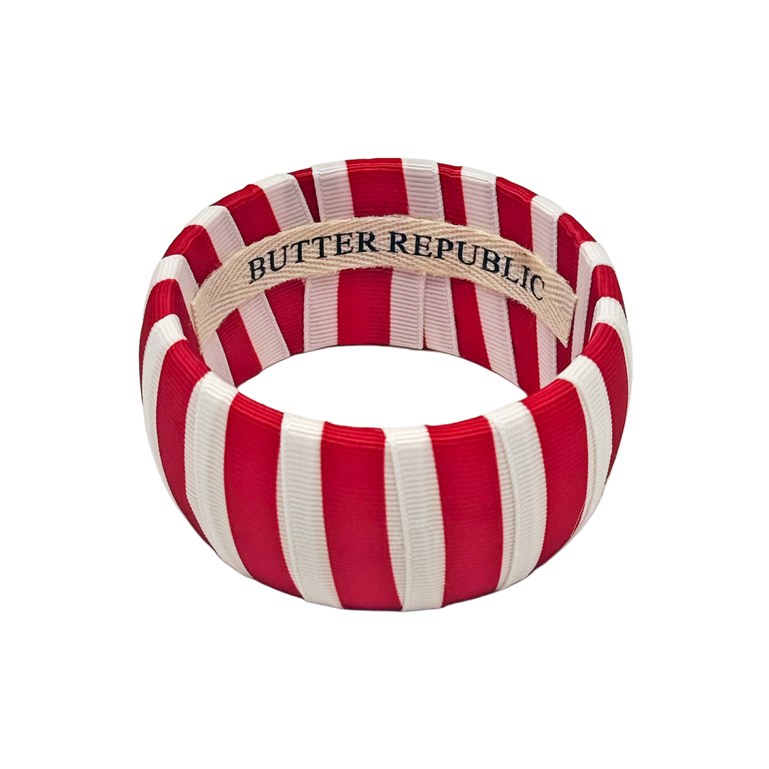 Red and white striped Butter Republic bracelet with brand label on the interior