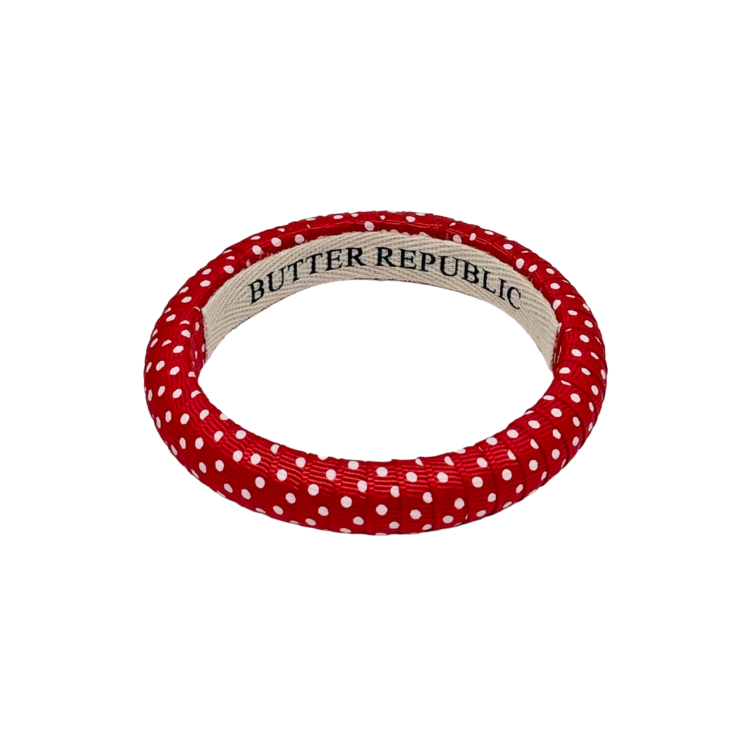Red and white Swiss dot bracelet with 'Butter Republic' label on the interior