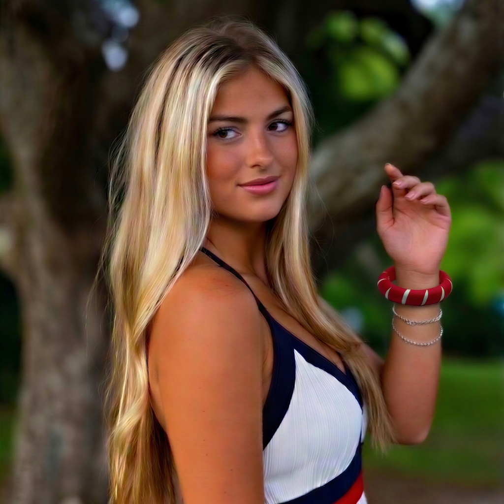 a young oman in a white dress, wearing a red and white Butter Republic bangle bracelet, standing outdoors near a tree