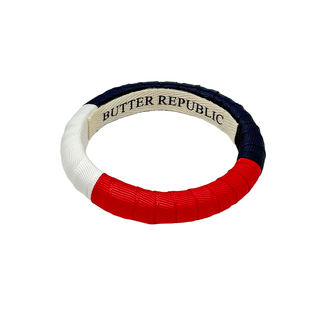 Red, white, navy blue color block bracelet with Butter Republic branding label on the interior