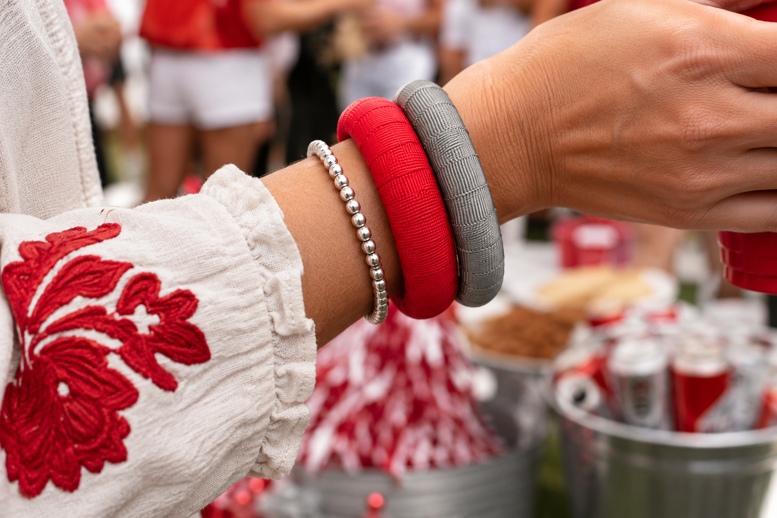 A close-up of a person's wrist wearing Butter Republic bracelets