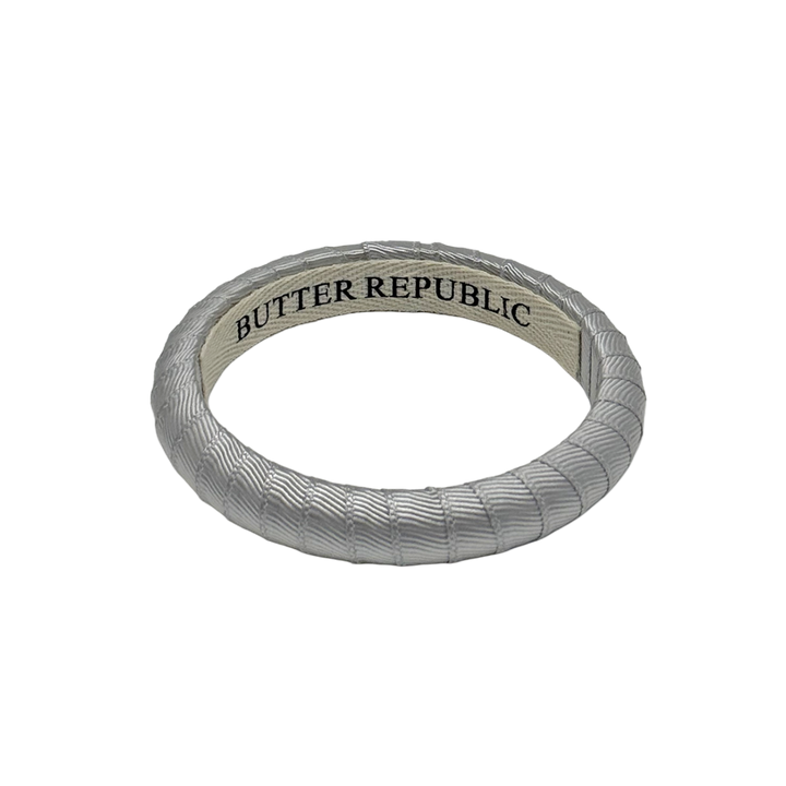 silver Butter Republic bracelet with a logo brand label on the interior of the bracelet
