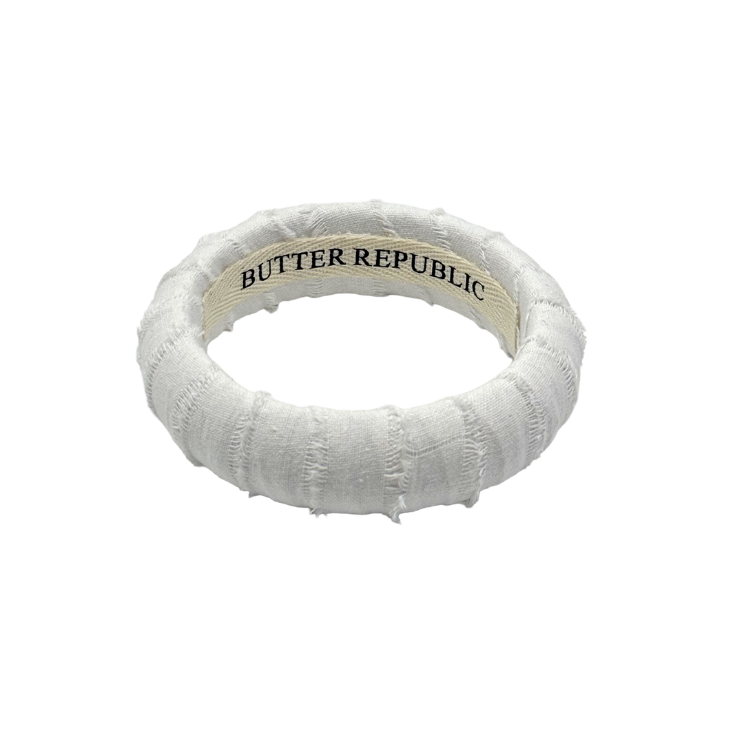 White textured bracelet with 'Butter Republic' label on the interior