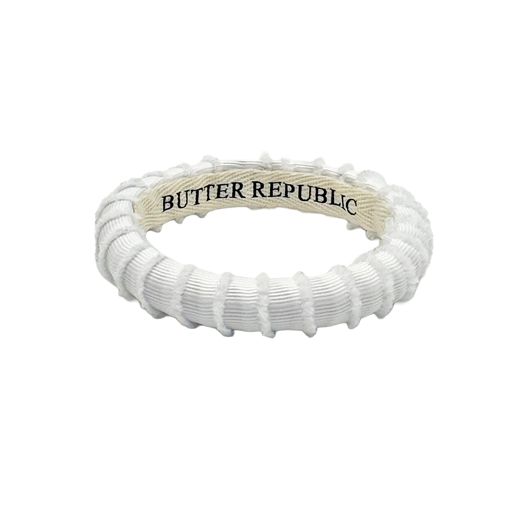 A white Butter Republic bracelet with a frayed edge ribbon