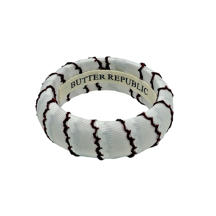white Butter Republic bracelet with maroon-edged thread with logo brand label visible on the interior of the bracelet