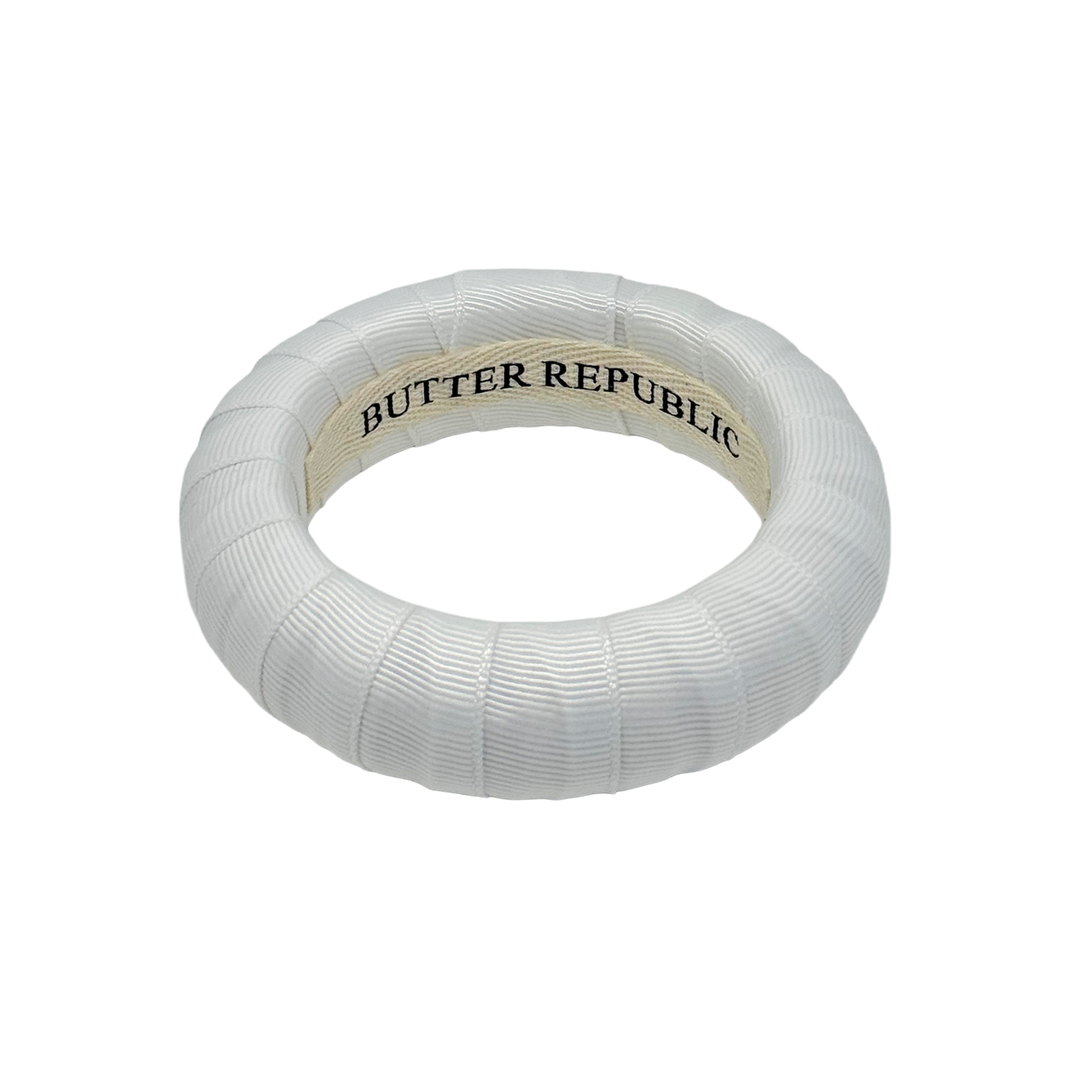White bracelet with 'Butter Republic' branding on the interior