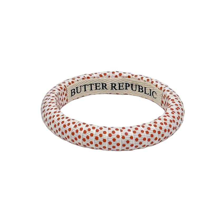 Narrow white Butter Republic bracelet with small Swiss dot orange polka dots