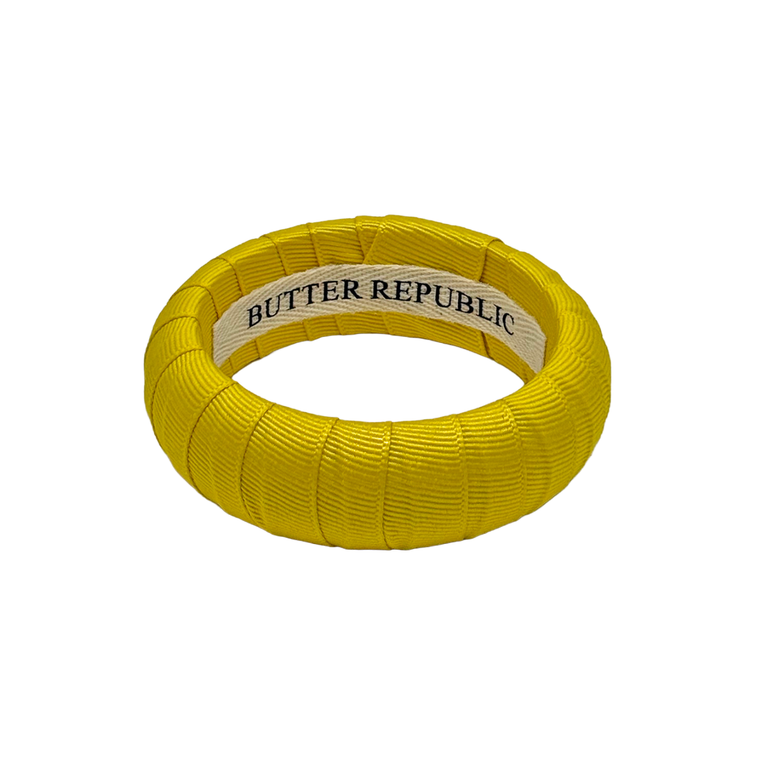 Yellow Butter Republic bangle bracelet with brand label on the interior